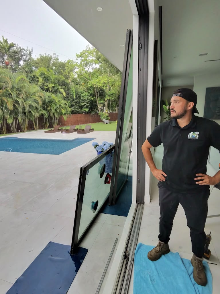 Sliding Doors Pro technician inspecting sliding glass door at luxury Miami home